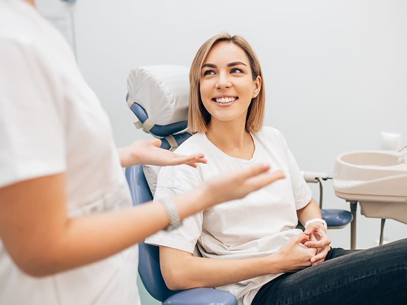 Patient talking with their dentistf